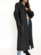 Black patterned leather coat detail